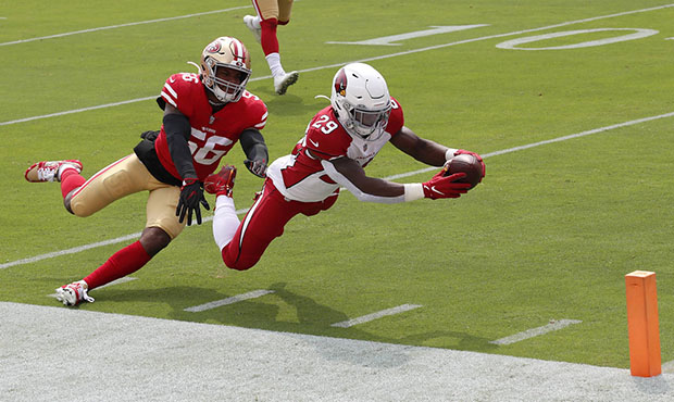 Arizona Cardinals running back Chase Edmonds (29) dives past San Francisco 49ers middle linebacker ...