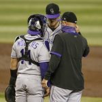 Colorado Rockies catcher Tony Wolters and pitching coach Steve Foster talk to Kyle Freeland during a rough first inning where he gave up two runs to the Arizona Diamondbacks during a baseball game Sunday, Sept. 27, 2020, in Phoenix. (AP Photo/Darryl Webb)