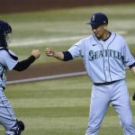 Seattle Mariners relief pitcher Yoshihisa Hirano, right, of Japan, does a fist bump with catcher Luis Torrens after the final out in the team's baseball game against the Arizona Diamondbacks on Saturday, Sept. 12, 2020, in Phoenix. The Mariners won 7-3. (AP Photo/Ross D. Franklin)