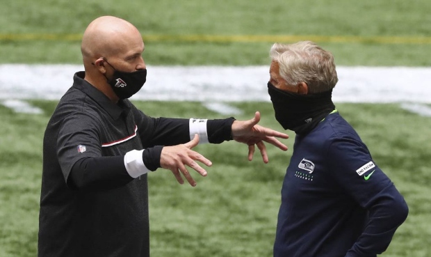 Atlanta Falcons head coach Dan Quinn, left, and Seattle Seahawks head coach Pete Carroll greet each...