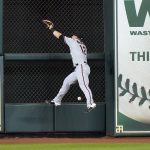 Arizona Diamondbacks center fielder Daulton Varsho (12) leaps at the wall while trying to catch a single by Houston Astros' Michael Brantley during the first inning of a baseball game Friday, Sept. 18, 2020, in Houston. (AP Photo/David J. Phillip)