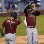 Arizona Diamondbacks' Christian Walker, right, celebrates his solo home run with David Peralta (6) during the sixth inning of the team's baseball game against the Los Angeles Dodgers on Wednesday, Sept. 2, 2020, in Los Angeles. (AP Photo/Marcio Jose Sanchez)