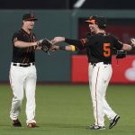 San Francisco Giants outfielders, from left, Alex Dickerson, Mauricio Dubon and Mike Yastrzemski celebrate at the end of a baseball game against the Arizona Diamondbacks on Saturday, Sept. 5, 2020, in San Francisco. San Francisco won 4-3. (AP Photo/Eric Risberg)