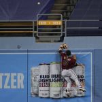 Arizona Diamondbacks center fielder Daulton Varsho leaps for but can't catch a solo home run by Los Angeles Dodgers' Mookie Betts during the ninth inning of a baseball game Wednesday, Sept. 2, 2020, in Los Angeles. (AP Photo/Marcio Jose Sanchez)