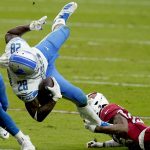 Detroit Lions running back Adrian Peterson (28) is tripped up by Arizona Cardinals safety Deionte Thompson during the first half of an NFL football game, Sunday, Sept. 27, 2020, in Glendale, Ariz. (AP Photo/Ross D. Franklin)