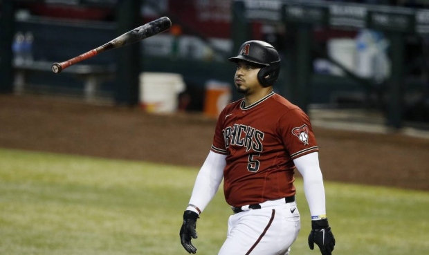 Arizona Diamondbacks' Eduardo Escobar flips his bat after a swinging strike during a baseball train...