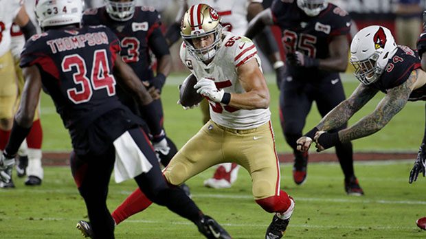 San Francisco 49ers tight end George Kittle (85) tries to avoid Arizona Cardinals defenders during ...