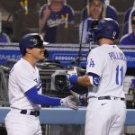 Los Angeles Dodgers' A.J. Pollock, right, is greeted by Enrique Hernandez after Pollock's solo home run during the seventh inning of the team's baseball game against the Arizona Diamondbacks on Thursday, Sept. 3, 2020, in Los Angeles. (AP Photo/Marcio Jose Sanchez)