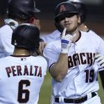 Arizona Diamondbacks' Josh VanMeter (19) celebrates his three-run home run against the Colorado Rockies with David Peralta (6) during the third inning during the second game of a baseball doubleheader Friday, Sept. 25, 2020, in Phoenix. (AP Photo/Ross D. Franklin)