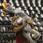 The Arizona Diamondbacks mascot, D. Baxter manhandles an imposter mascot Rat Leon after he infiltrated the stands during their baseball game against the Colorado Rockies Sunday, Sept. 27, 2020, in Phoenix. (AP Photo/Darryl Webb)