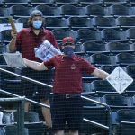 Members of the Chase Field grounds crew cheer on the Arizona Diamondbacks during the third inning of a baseball game against the Seattle Mariners Sunday, Sept. 13, 2020, in Phoenix. (AP Photo/Ross D. Franklin)
