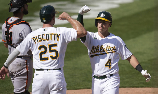 Oakland Athletics' Jake Lamb, left, is congratulated by Sean Murphy after hitting a solo home run a...