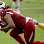 Arizona Cardinals wide receiver Larry Fitzgerald (11) is tackled by Washington Football Team cornerback Jimmy Moreland (20) during the first half of an NFL football game, Sunday, Sept. 20, 2020, in Glendale, Ariz. (AP Photo/Darryl Webb)