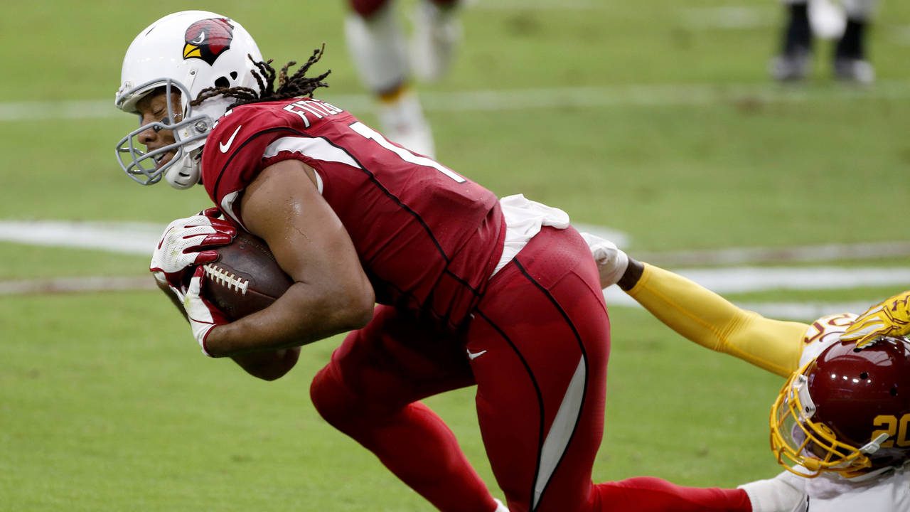 Arizona Cardinals wide receiver Larry Fitzgerald (11) is tackled by Washington Football Team corner...