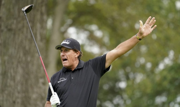 Phil Mickelson, of the United States, reacts after playing his shot from the sixth tee during the f...