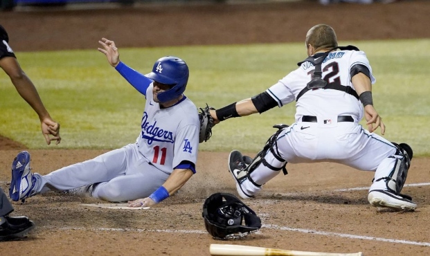 Los Angeles Dodgers' A.J. Pollock scores on a ground ball by Chris Taylor as Arizona Diamondbacks c...