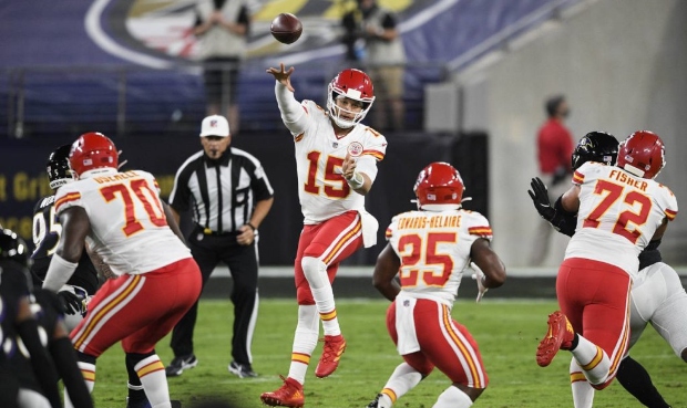 Kansas City Chiefs quarterback Patrick Mahomes (15) jumps to pass the ball during the first half of...