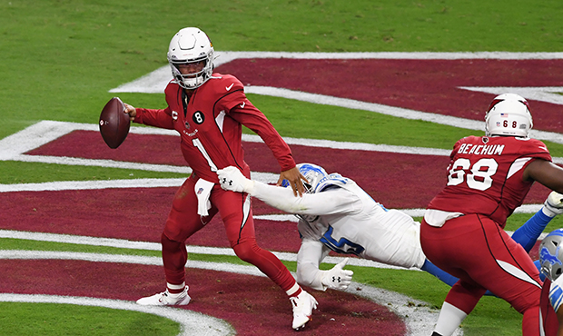 Kyler Murray #1 of the Arizona Cardinals breaks a tackle in his own end zone by Romeo Okwara #95 of...