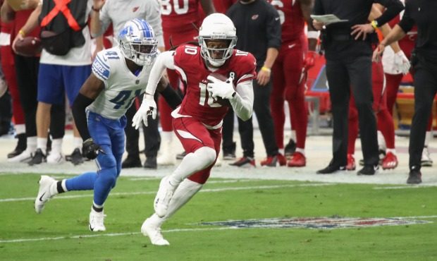 Wide receiver DeAndre Hopkins #10 of the Arizona Cardinals runs with the football past defensive ba...