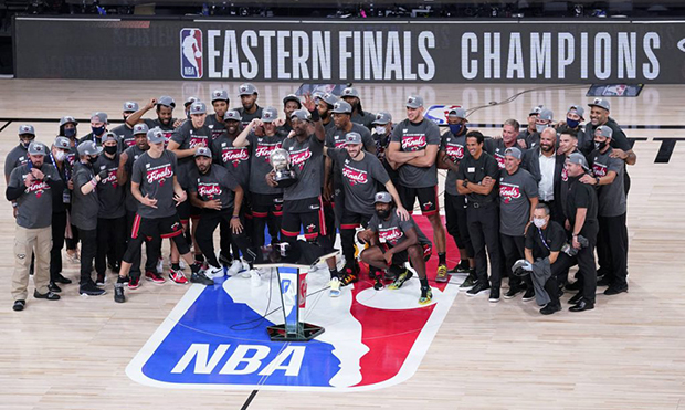 The Miami Heat celebrate their NBA conference final playoff basketball game win over the Boston Cel...