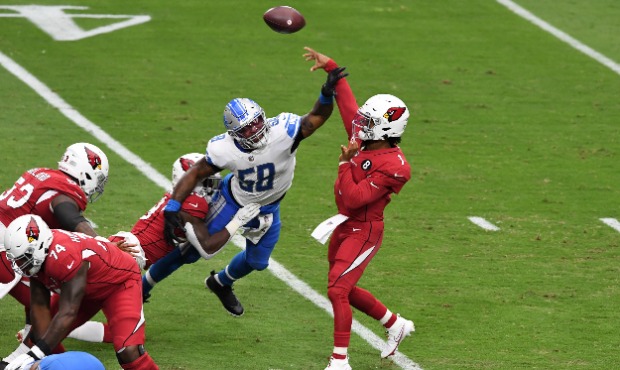 Kyler Murray #1 of the Arizona Cardinals has his arm hit while throwing the ball by Jamie Collins S...