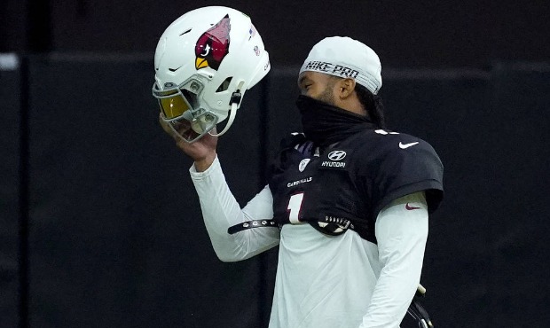 Arizona Cardinals quarterback Kyler Murray puts on his helmet during an NFL football training camp ...