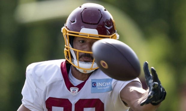 Washington tight end Logan Thomas reaches for the ball during practice at the team's NFL football t...