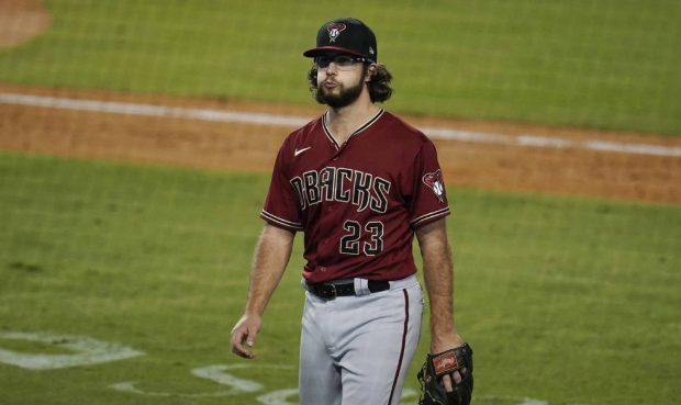 Arizona Diamondbacks starting pitcher Zac Gallen walks off the field after being pulled during the ...