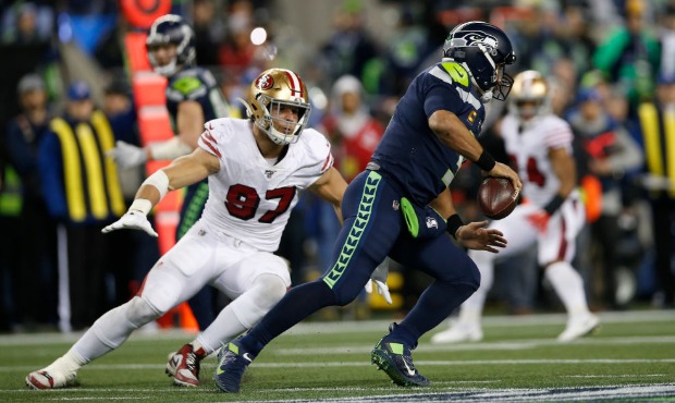 SEATTLE, WA - DECEMBER 29: Nick Bosa #97 of the San Francisco 49ers pressures Russell Wilson #3 of ...