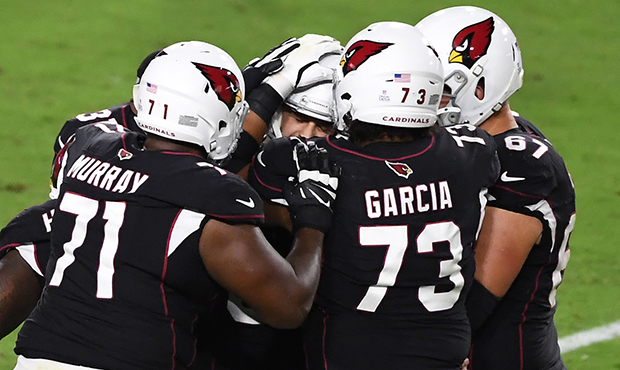 Zane Gonzales #5 of the Arizona Cardinals celebrates with teammates after kicking a game winning 48...