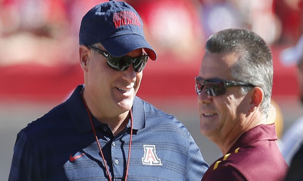 Arizona head coach Rich Rodriguez, right, talks with Arizona State head coach Todd Graham before an...