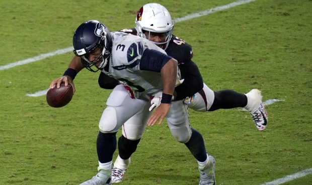 Seattle Seahawks quarterback Russell Wilson (3) is hit by Arizona Cardinals outside linebacker Haas...