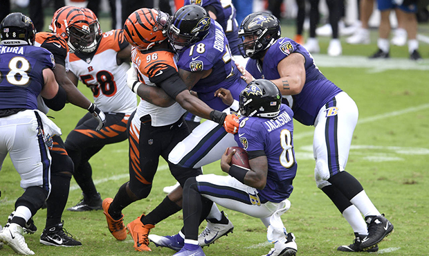 Cincinnati Bengals defensive end Carlos Dunlap (96) is able to sack Baltimore Ravens quarterback La...