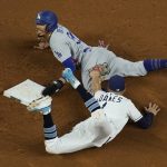 Los Angeles Dodgers' Mookie Betts steals second past Tampa Bay Rays shortstop Willy Adames during the sixth inning in Game 3 of the baseball World Series Friday, Oct. 23, 2020, in Arlington, Texas. (AP Photo/David J. Phillip)