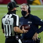 Seattle Seahawks head coach Pete Carroll talks with line judge Tim Podraza (47) during the second half of an NFL football game against the Arizona Cardinals, Sunday, Oct. 25, 2020, in Glendale, Ariz. (AP Photo/Rick Scuteri)