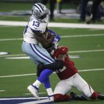 Dallas Cowboys wide receiver Michael Gallup (13) catches a pass for a first down as Arizona Cardinals safety Budda Baker (32) makes the stop in the first half of an NFL football game in Arlington, Texas, Monday, Oct. 19, 2020. (AP Photo/Michael Ainsworth)
