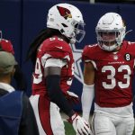 Arizona Cardinals' Budda Baker (32), De'Vondre Campbell (59) and Byron Murphy Jr. (33) celebrate a Dallas Cowboys turnover recovered by Murphy Jr., in the first half of an NFL football game in Arlington, Texas, Monday, Oct. 19, 2020. (AP Photo/Michael Ainsworth)