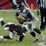 Seattle Seahawks quarterback Russell Wilson (3) escapes the reach of Arizona Cardinals outside linebacker Devon Kennard (42) during the second half of an NFL football game, Sunday, Oct. 25, 2020, in Glendale, Ariz. (AP Photo/Rick Scuteri)
