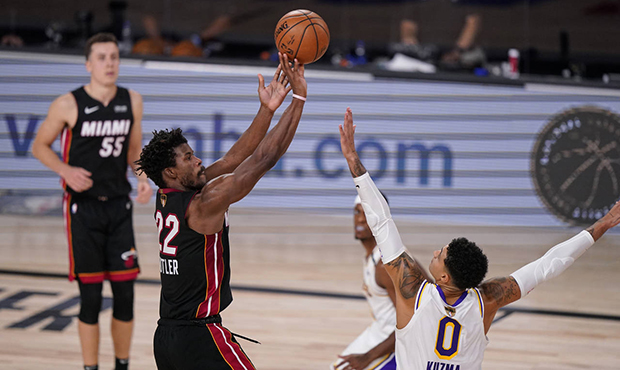Miami Heat's Jimmy Butler (22) shoots against Los Angeles Lakers' Kyle Kuzma (0) during the second ...