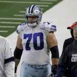 Dallas Cowboys guard Zack Martin (70) is escorted off the field after suffering an unknown injury in the first half of an NFL football game against the Arizona Cardinals in Arlington, Texas, Monday, Oct. 19, 2020. (AP Photo/Ron Jenkins)