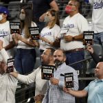 Fans participate a "Stand Up to Cancer" moment during in Game 3 of the baseball World Series between the Los Angeles Dodgers and the Tampa Bay Rays Friday, Oct. 23, 2020, in Arlington, Texas. (AP Photo/Tony Gutierrez)