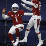 Arizona Cardinals' Kyler Murray (1) and DeAndre Hopkins (10) celebrate a touchdown scored on a carry by Murray in the second half of an NFL football game against the Dallas Cowboys in Arlington, Texas, Monday, Oct. 19, 2020. (AP Photo/Ron Jenkins)