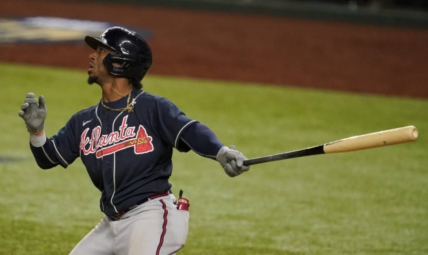 Atlanta Braves' Ozzie Albies hits a home run against the Los Angeles Dodgers during the ninth innin...