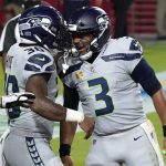 Seattle Seahawks running back Carlos Hyde (30) celebrates his touchdown with quarterback Russell Wilson (3) during the first half of an NFL football game against the Arizona Cardinals, Sunday, Oct. 25, 2020, in Glendale, Ariz. (AP Photo/Rick Scuteri)
