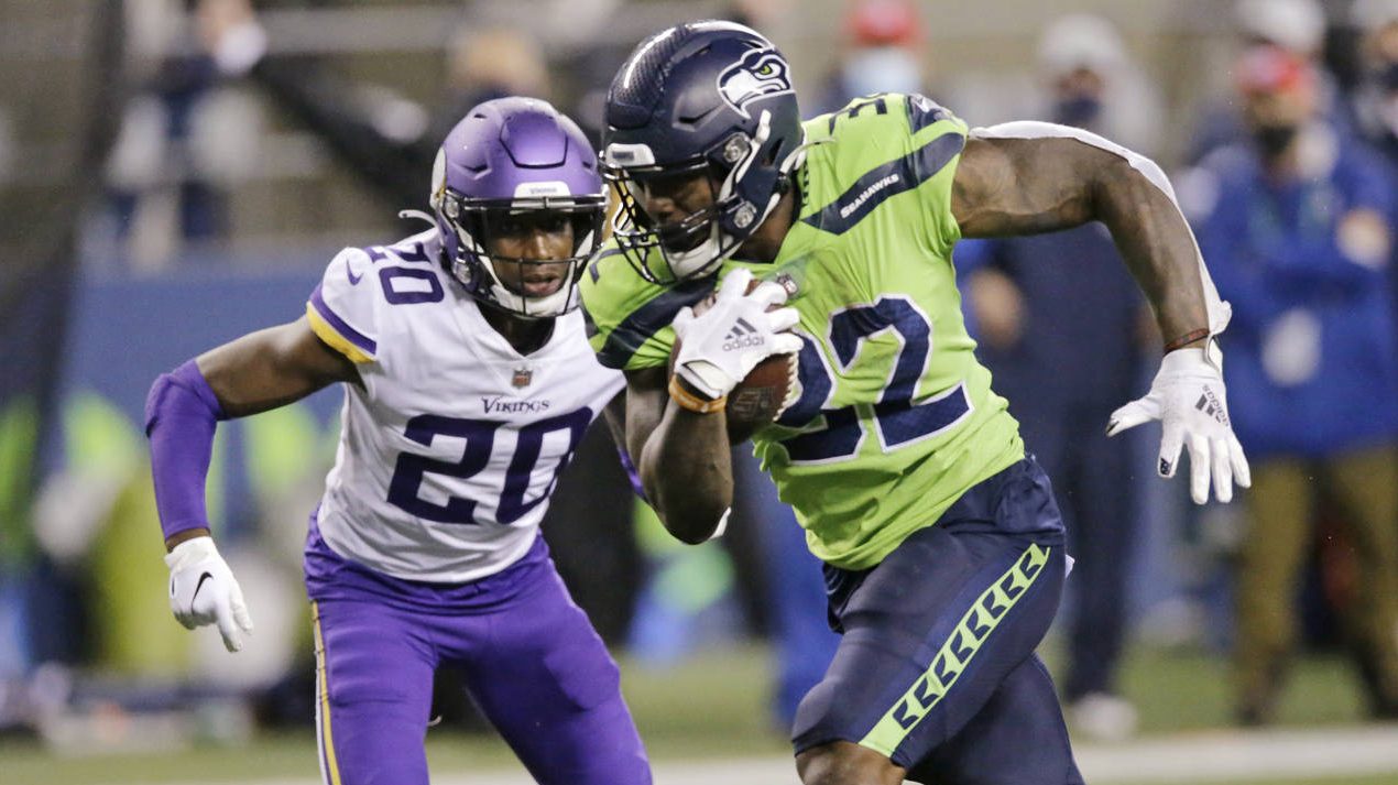 Seattle Seahawks' Chris Carson rushes for a touchdown as Minnesota Vikings' Jeff Gladney gives chas...