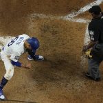 Los Angeles Dodgers' Mookie Betts reacts after scoring on a fielders choice by Max Muncy during the fifth inning in Game 1 of the baseball World Series against the Tampa Bay Rays Tuesday, Oct. 20, 2020, in Arlington, Texas. (AP Photo/David J. Phillip)