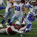 Arizona Cardinals defensive tackle Corey Peters (98) attempts to stop Dallas Cowboys running back Ezekiel Elliott (21) in the first half of an NFL football game in Arlington, Texas, Monday, Oct. 19, 2020. (AP Photo/Michael Ainsworth)