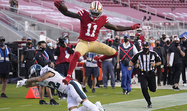 San Francisco 49ers wide receiver Brandon Aiyuk (11) jumps past Philadelphia Eagles safety Marcus E...
