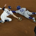 Los Angeles Dodgers' Mookie Betts steals second past Tampa Bay Rays shortstop Willy Adames during the sixth inning in Game 3 of the baseball World Series Friday, Oct. 23, 2020, in Arlington, Texas. (AP Photo/David J. Phillip)
