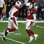 Arizona Cardinals' Angelo Blackson (96) and Haason Reddick (43) celebrate their combined effort to sack Dallas Cowboys quarterback Andy Dalton (14) in the first half of an NFL football game in Arlington, Texas, Monday, Oct. 19, 2020. (AP Photo/Michael Ainsworth)